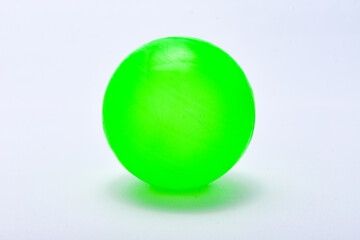 Green plastic ball isolated on white background