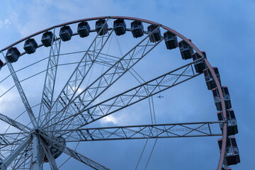 Barcelona, Spain - December 9, 2024: Large Ferris Wheel Against Cloudy Skies During Overcast Evening
