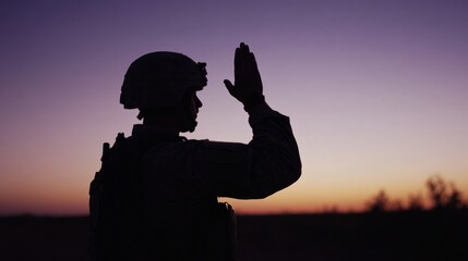 Fototapeta premium Soldier saluting in silhouette against sunset, embodying honor and resilience.