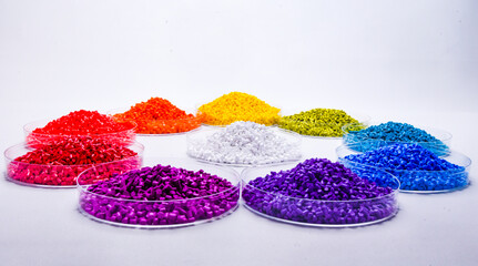 Various colors of masterbatch granules in petri dish isolated on white background,color pigment...