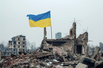 The Victory of Ukraine flag on the ruins of the destroyed and burning city and buildings.	
