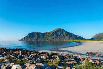 Aerial view overlooking Skagsanden Beach near Flakstad. In the background, the summit of Hustinden. Lofoten District in Norway