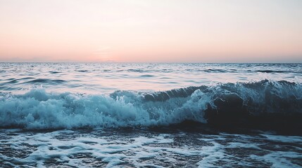 Fototapeta premium Ocean wave crashing on shore at sunset