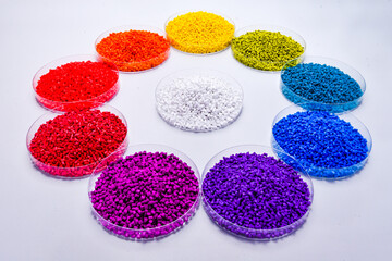 Various colors of masterbatch granules in petri dish isolated on white background,color pigment...