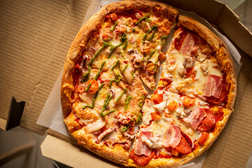 A delicious half-and-half pizza with fresh toppings, melted cheese, and a golden crust, served in a cardboard box—perfect for a tasty meal