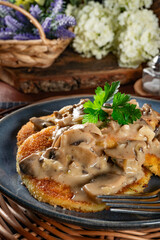Potato cutlets with mushroom sauce.