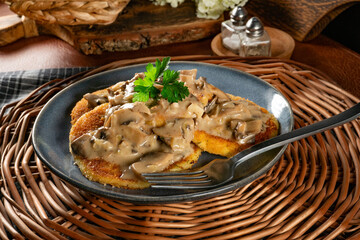 Potato cutlets with mushroom sauce.