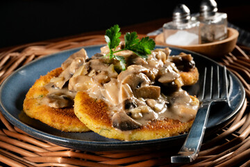 Potato cutlets with mushroom sauce.