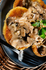 Potato cutlets with mushroom sauce.