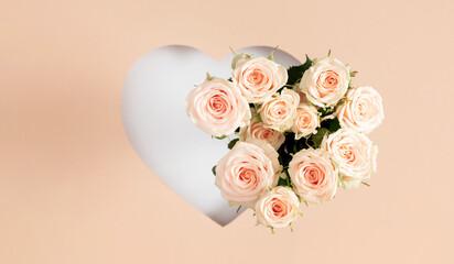 Gorgeous bouquet of cream roses inside a heart-shaped frame outline on a light background. Easter, Valentine's Day, Mother's Day, Wedding.