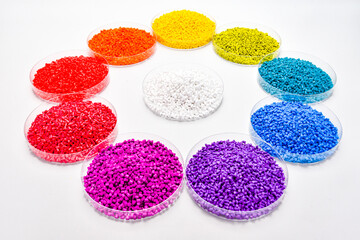 Various colors of masterbatch granules in petri dish isolated on white background,color pigment...