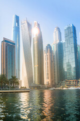 Obraz premium Dubai Marina skyscrapers view at sunset. Panoramic view from boat