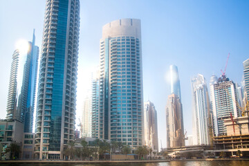 Obraz premium Dubai Marina skyscrapers view at sunset. Panoramic view from boat