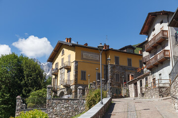 GROMO, ITALY - MAY 22, 2024: Street view of historical village with narrow cobbled streets, shot in bright summer light