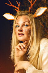 Face art close-up. Drawing on the face. Woman painted as a deer. Drawing of an animal on the face.