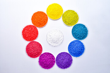 Various colors of masterbatch granules in petri dish isolated on white background,color pigment...