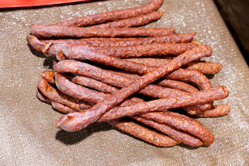 Close up composition of traditional hungarian homemade specialty foods, salami sausage etc. on farmers market for sale. Pile of delicious regional homemade products in row