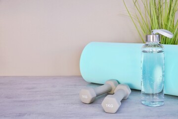 Mat and dumbbells for fitness training. Slimness and healthy lifestyle.