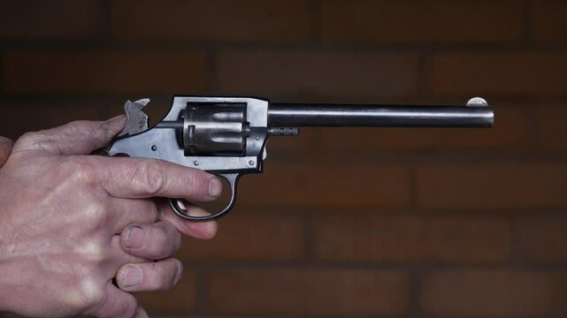 Pulling the trigger on a classic revolver hand gun