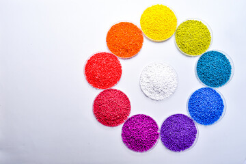Various colors of masterbatch granules in petri dish isolated on white background,color pigment...