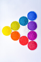 Various colors of masterbatch granules in petri dish isolated on white background,color pigment...