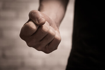 Close-up of a clenched fist, symbolizing aggression, anger, and violence. A powerful stock photo for topics on conflict, emotions, self-defense, and social issues.