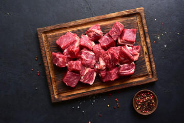 Cubes of raw organic meat ( beef or lamb ). Top view with copy space.