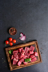 Cubes of raw organic meat ( beef or lamb ). Top view with copy space.