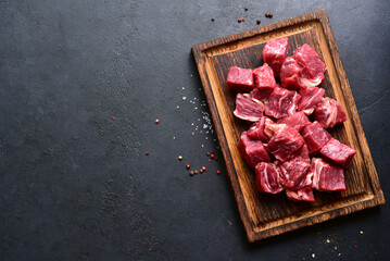 Cubes of raw organic meat ( beef or lamb ). Top view with copy space.