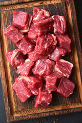 Cubes of raw organic meat ( beef or lamb ). Top view with copy space.