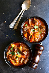 Goulash (meat stew with tomatoes and paprika) - traditional dish of hungarian cuisine.Top view with copy space.