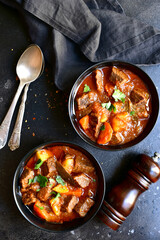 Goulash (meat stew with tomatoes and paprika) - traditional dish of hungarian cuisine.Top view with copy space.