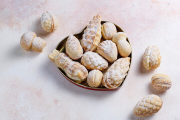 Homemade nut shaped russian soviet cookies and wafer rolls with pastry cream.