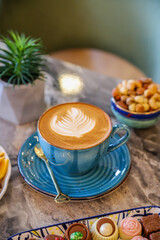 Cup with hot cappuccino with foam on the table. coffee art.