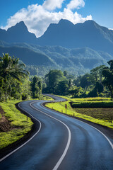 Fototapeta premium Serene Winding Road Through Lush Landscapes Leading to Majestic Mountain Range Under Clear Blue Sky