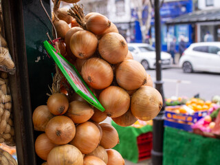 Stringed  fresh onions at market