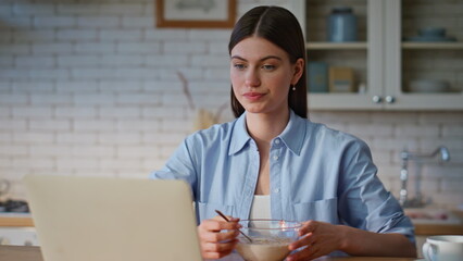 Housewife looking laptop kitchen sipping tea closeup. Remote student breakfast