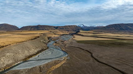 Drone  view of the Ashburton highlands with a river and lake in the dry arid terrain on the way to Lake Heron