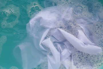 White cloth soaked in powder detergent water dissolution, washing cloth. Laundry concept