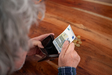 Elderly person counting last Euros