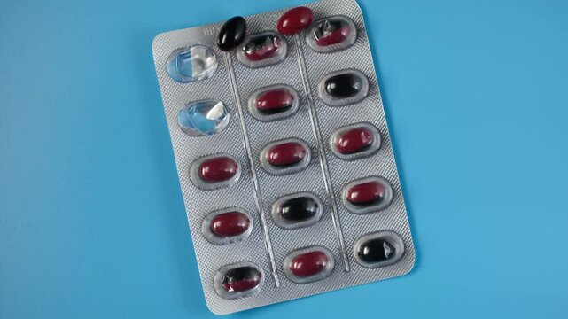 Opened package of pills for treatment of erectile dysfunction, frequent urination and prostate adenoma, close-up. Traditional treatment, medications, capsules. 4K video, rotating.