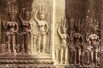 Carved statues of dancing apsaras celestial nymphs on the walls of Angkor Wat, Siem Reap, Cambodia