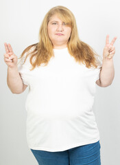 Fototapeta premium Blonde Plus Size Woman Making Peace Sign with Both Hands