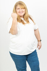Fototapeta premium Blonde Plus Size Woman Smiling with Fist Raised in Success Gesture