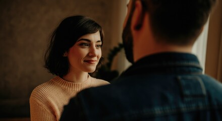 Woman smiling at man indoors cozy setting