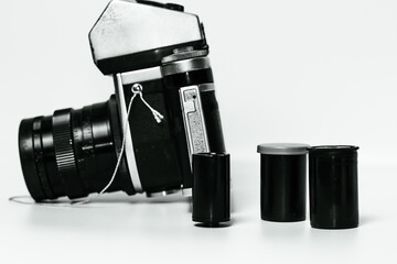 Collectible film camera, vintage analog camera and film for it, retro equipment in a metal case.