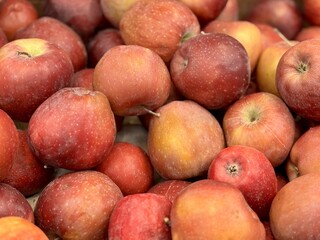 Box filled with fresh natural bio organic red apples placed on counter in local food market