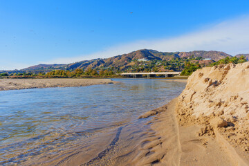 Malibu Beach: Riverbank Meeting Ocean with Scenic Hills in Background