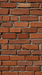 Obraz premium Red Brick Wall Texture: A close-up view of a textured red brick wall, showcasing the intricate patterns and subtle variations in the brickwork.