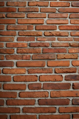 Fototapeta premium Brick Wall Texture: A detailed close-up shot reveals the rich texture and subtle variations in color of a classic red brick wall. Perfect for adding a rustic or industrial feel to your designs.